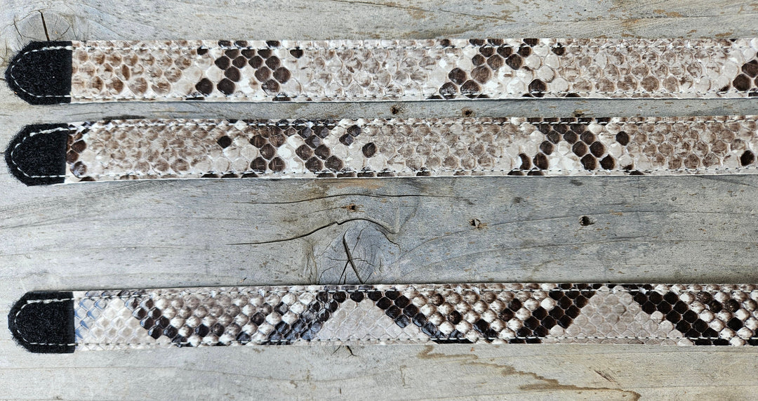The Headliner Python Snake Skin Hatband is cut to show the back pattern. This band is 1" in width and adjust with a Velcro loop that you can tighten or loose to fit your favorite hats. You can bring your hat and try them out if you come to our Smyrna, TN shop not far from Nashville.

Please keep in mind the patterns will ALWAYS vary since this is a natural skin, these are NOT manufactured skins.
Center Cut is a more defined scale pattern&amp;nbsp;
Side cut has more a mix of colors