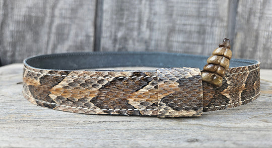 This Natural Southern Rattler Eastern Canebrake Rattlesnake Skin Hatband has a Rattle at the end of the band. It has more a Striped Copper pattern than a traditional Diamondback. Actual snakeskin with a pigskin backing and adjustment with a Velcro loop that you can tighten or loose to fit your favorite hats. You can bring your hat and try them out if you come to our Smyrna, TN shop not far from Nashville.

