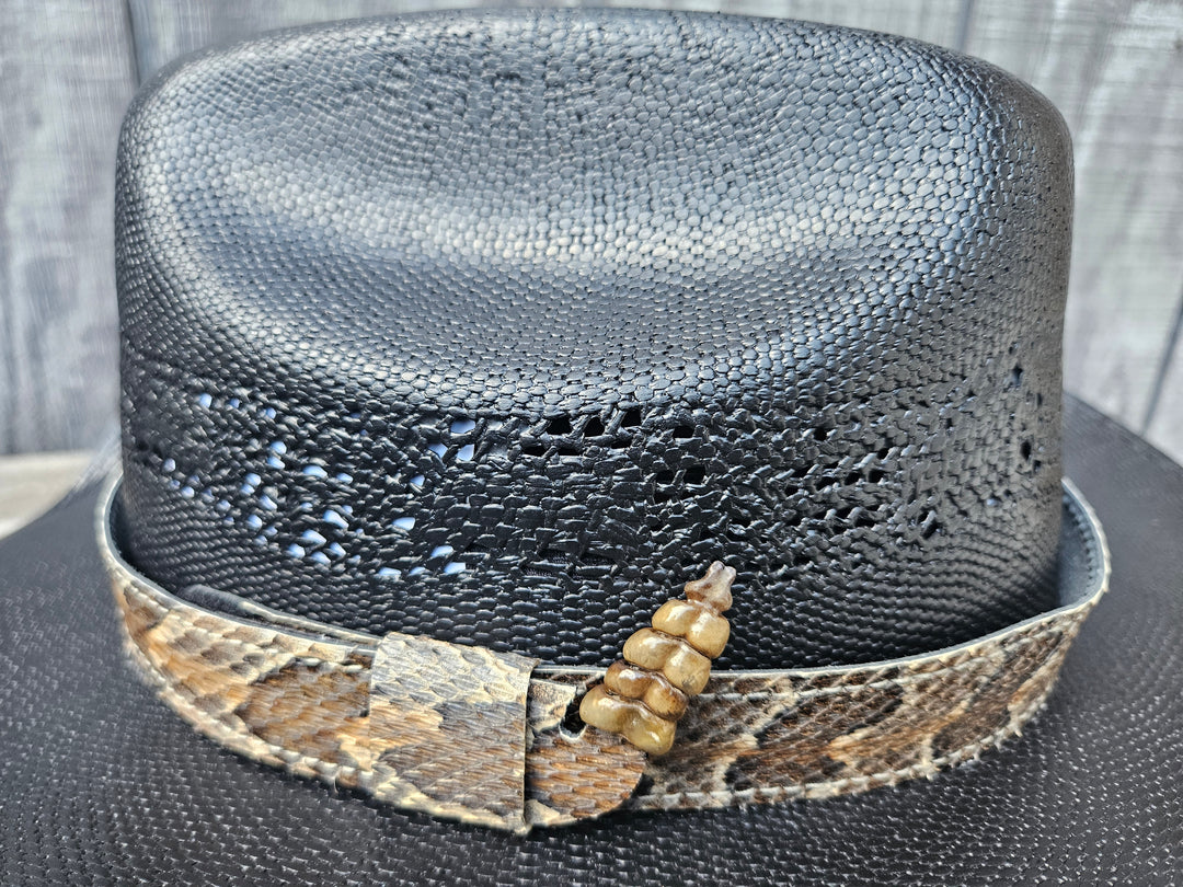 This Natural Southern Rattler Eastern Canebrake Rattlesnake Skin Hatband has a Rattle at the end of the band. It has more a Striped Copper pattern than a traditional Diamondback. Actual snakeskin with a pigskin backing and adjustment with a Velcro loop that you can tighten or loose to fit your favorite hats. You can bring your hat and try them out if you come to our Smyrna, TN shop not far from Nashville.

1" width