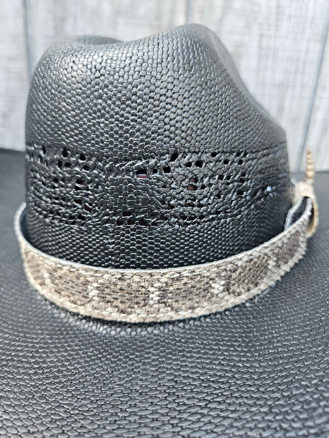 This is a Western Diamondback Snake Skin Hatband. The Western pattern is a little less defined than the Eastern or a Canebrake. The have a Rattler at the of the band that points up slightly and will connect together with a velcro adjustmentand a sliding keeper. Authentic Rattlesnake skin with a pigskin back. Of course you can pick them out if you come to our Smyrna, TN shop not far from Nashville.