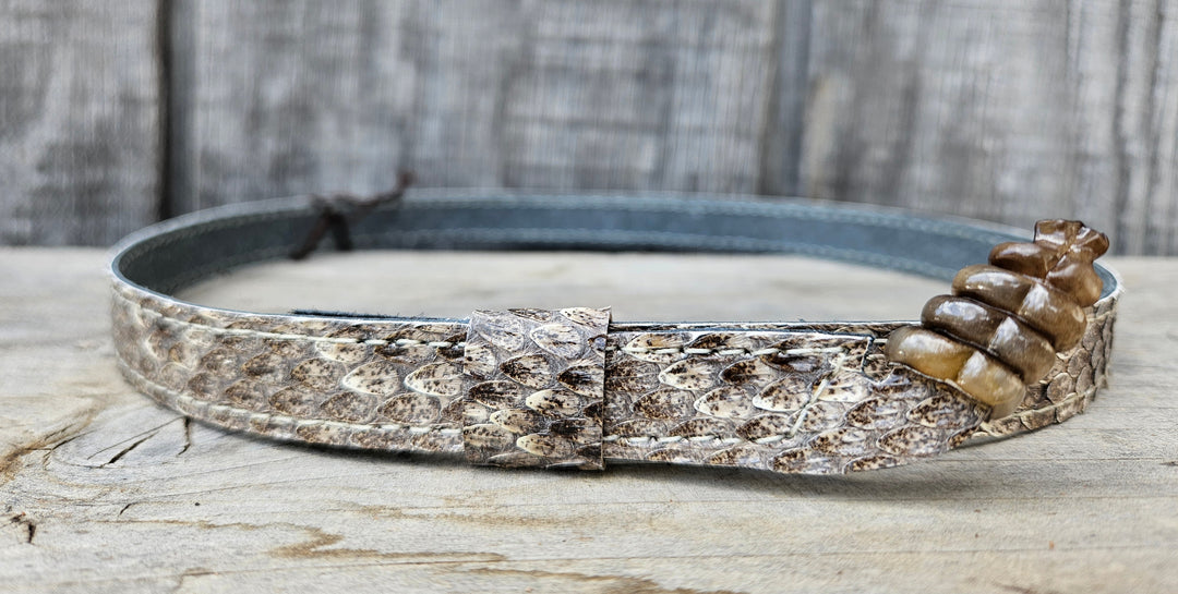 This is a Western Diamondback Snake Skin Hatband. The Western pattern is a little less defined than the Eastern or a Canebrake. The have a Rattler at the of the band that points up slightly and will connect together with a velcro adjustmentand a sliding keeper. Authentic Rattlesnake skin with a pigskin back. Of course you can pick them out if you come to our Smyrna, TN shop not far from Nashville.