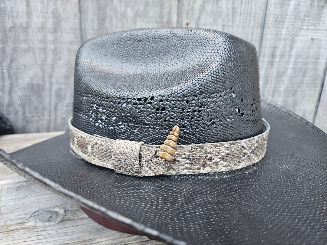 This is a Western Diamondback Snake Skin Hatband. The Western pattern is a little less defined than the Eastern or a Canebrake. The have a Rattler at the of the band that points up slightly and will connect together with a velcro adjustmentand a sliding keeper. Authentic Rattlesnake skin with a pigskin back. Of course you can pick them out if you come to our Smyrna, TN shop not far from Nashville.