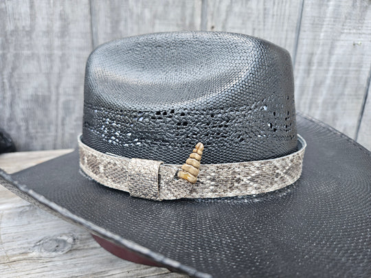 This is a Western Diamondback Snake Skin Hatband. The Western pattern is a little less defined than the Eastern or a Canebrake. The have a Rattler at the of the band that points up slightly and will connect together with a velcro adjustmentand a sliding keeper. Authentic Rattlesnake skin with a pigskin back. Of course you can pick them out if you come to our Smyrna, TN shop not far from Nashville.