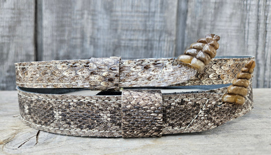 This is a Western Diamondback Snake Skin Hatband. The Western pattern is a little less defined than the Eastern or a Canebrake. The have a Rattler at the of the band that points up slightly and will connect together with a velcro adjustmentand a sliding keeper. Authentic Rattlesnake skin with a pigskin back. Of course you can pick them out if you come to our Smyrna, TN shop not far from Nashville.