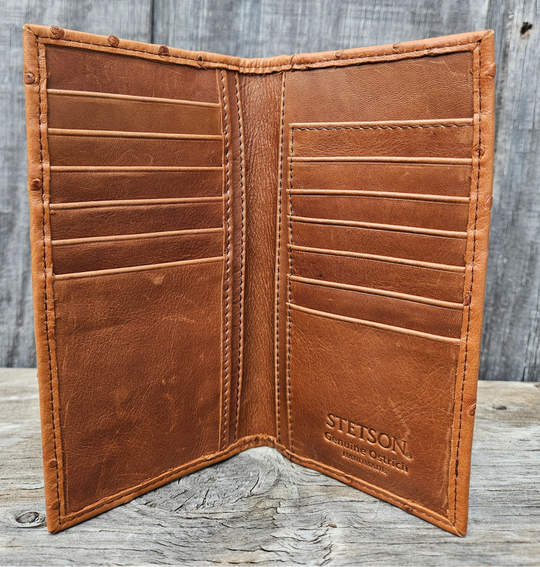 The Stetson Ostrich Long Wallet is made from authentic Ostrich leather in a Antique Cognac color, this Long checkbook wallet blends classic western style with bold luxury. The Stetson name guarantees top-notch craftsmanship and meticulous detail. It offers 12 card slots, 3 hidden pockets underneath, plus an outside cash slot. Available now at our Smyrna, TN store, just a quick 30-minute drive from downtown Nashville. Proudly made in Mexico.

Size 6 5/8" tall x 3 1/2" wide (folded)