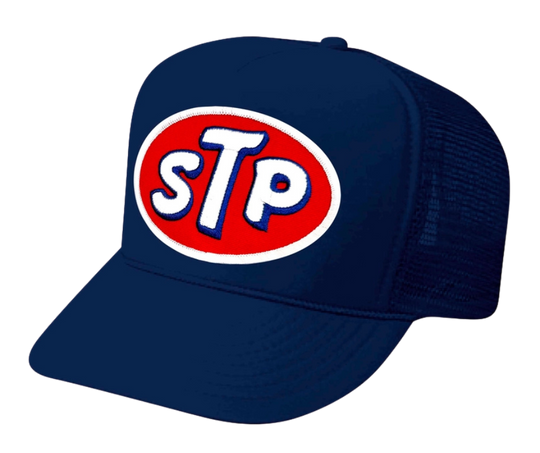 This STP hat is part of our new Navy Blue Foam Front Classic Trucker Hat Collection. This Curved Bill mesh back trucker hat features a big Vintage STP Embroidered Patch sewn on the front panel making this is as old school cool as it gets! Snapback one size fits most y’all.&nbsp;Get yours now at our Smyrna, TN store or online!