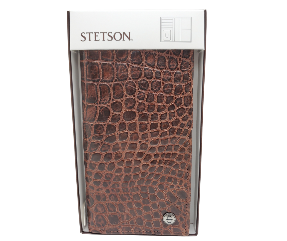 Fully Licensed Stetson Logo Roper/Checkbook style Wallet. Made from Cognac Brown Croc or Black print cowhide leather so good it's really hard to tell the difference from the real thing! Classic Roper design on the inside made from soft durable cowhide leather. Featuring on the left inside 6 card slots and I.D. pocket along 2 underside pockets. On the right inside 1 under pocket with a additional slot on top. In stock at our Smyrna, TN retail store 30 min. from downtown Nashville. Imported.