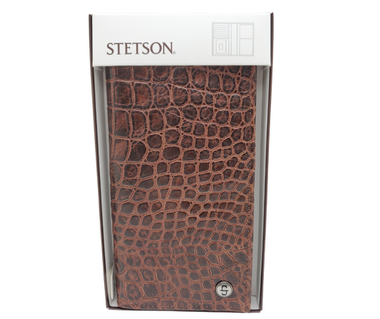 Fully Licensed Stetson Logo Roper/Checkbook style Wallet. Made from Cognac Brown Croc or Black print cowhide leather so good it's really hard to tell the difference from the real thing! Classic Roper design on the inside made from soft durable cowhide leather. Featuring on the left inside 6 card slots and I.D. pocket along 2 underside pockets. On the right inside 1 under pocket with a additional slot on top. In stock at our Smyrna, TN retail store 30 min. from downtown Nashville. Imported.