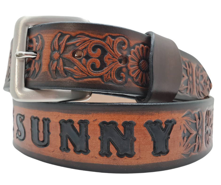 "The Sun Daisy" is a handmade real VEGTAN belt made from a single strip of cowhide shoulder leather that is 8-10 oz. or approx. 1/8" thick. It has hand burnished (smoothed) & edges and Summer flowers embossed on the surface. The antique nickel plated solid brass buckle is snapped in place with heavy snaps. This belt is made just outside Nashville in Smyrna, TN.