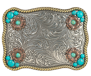 Sunsets are a divine gift. The "Sunset Flower" Belt Buckle takes your mind to one. Its rectangular shape, rope edge, and western floral background are accented by small Turquoise stones and Copper flowers. At 2 1/2" tall by 3 1/2" wide, this versatile buckle fits belts up to 1 1/2" wide and is available at our retail store in Smyrna, TN, near Nashville. We can't wait for you to see it!