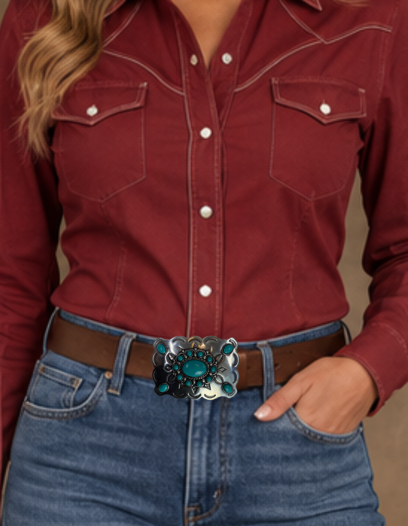 Southwestern style belt buckle with Southwestern tooling, scalloped design around edges, and simulated turquoise stones, approx. size 3 1/2" wide by 2 1/2" tall.  Color is antique silver, buckle is made of zinc. Fits belts 1 1/2" wide. Available online and in our shop just outside Nashville in Smyrna, TN. Back of buckle is pictured.
