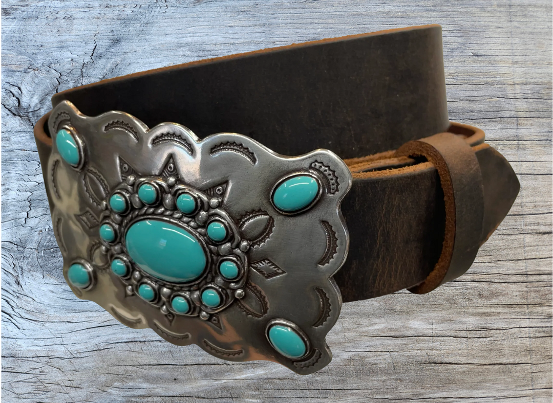 Southwestern style belt buckle with Southwestern tooling, scalloped design around edges, and simulated turquoise stones, approx. size 3 1/2" wide by 2 1/2" tall.  Color is antique silver, buckle is made of zinc. Fits belts 1 1/2" wide. Belt is handmade from a single strip of leather, choose from either distressed brown, black, or dark brown. CHOOSE ONE BELT STRIP COLOR! Available online and in our shop just outside Nashville in Smyrna, TN. Distressed brown belt.