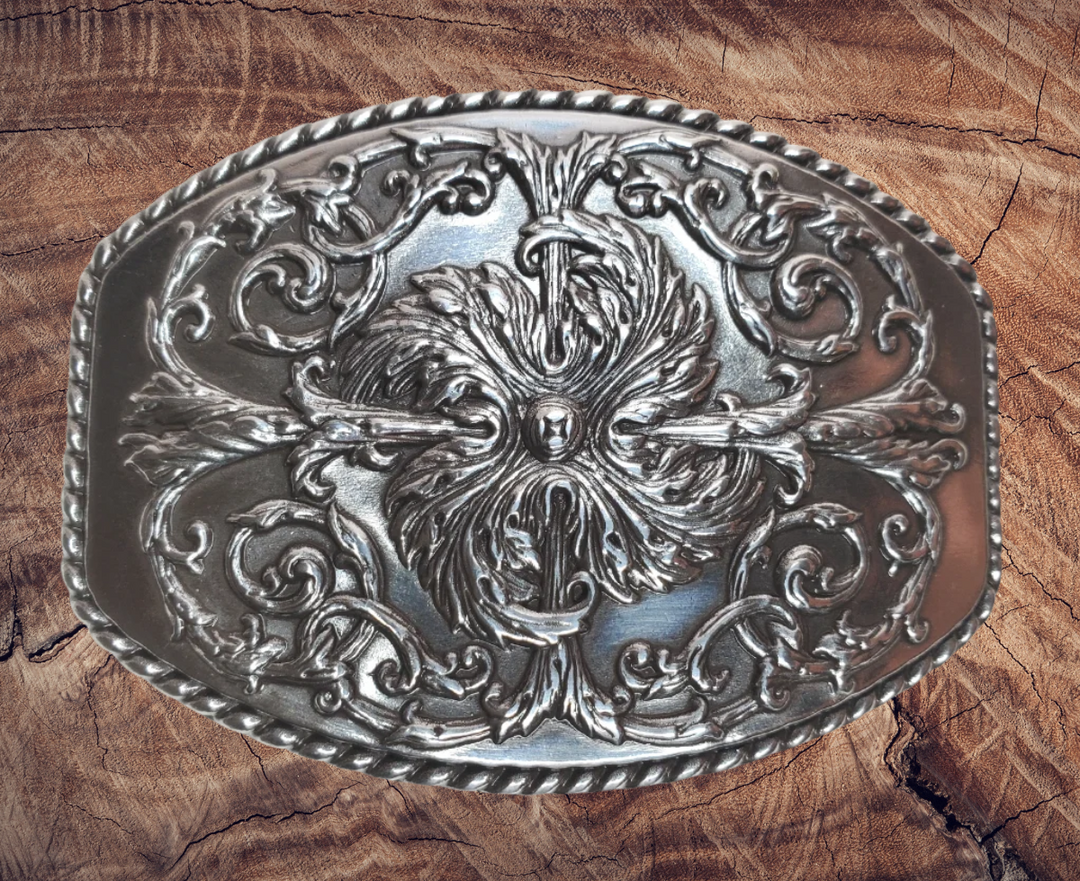 This stylish Antique Silver buckle features an Oval shape with a raised western scroll pattern. It is designed to fit 1 1/2" belts and measures approximately 2.5" x.3", Imported