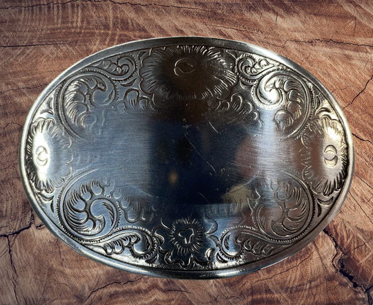 Oval shaped antique silver colored belt buckle with western style tooling, Smaller size approx. 3"wide by 2" tall. Available online and at our shop just outside Nashville in Smyrna, TN. Buckle is imported and made from zinc.