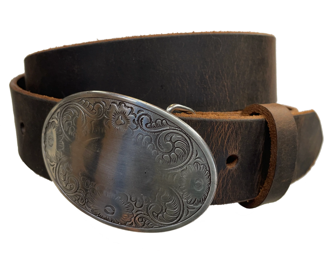 "The Silverton" is an oval shaped & antique silver colored belt buckle with Western style tooling design, Smaller sized approx. 3" wide by 2" tall. CHOOSE ONE BELT STRIP COLOR! Belt is a solid strip of leather and made in our shop in Smyrna, TN, just outside of Nashville. Belt is 1 1/2" wide, choose from either distressed brown, black, or dark brown. Sizes available from 34"-44". Buckle is imported. Available in our retail and online shops.