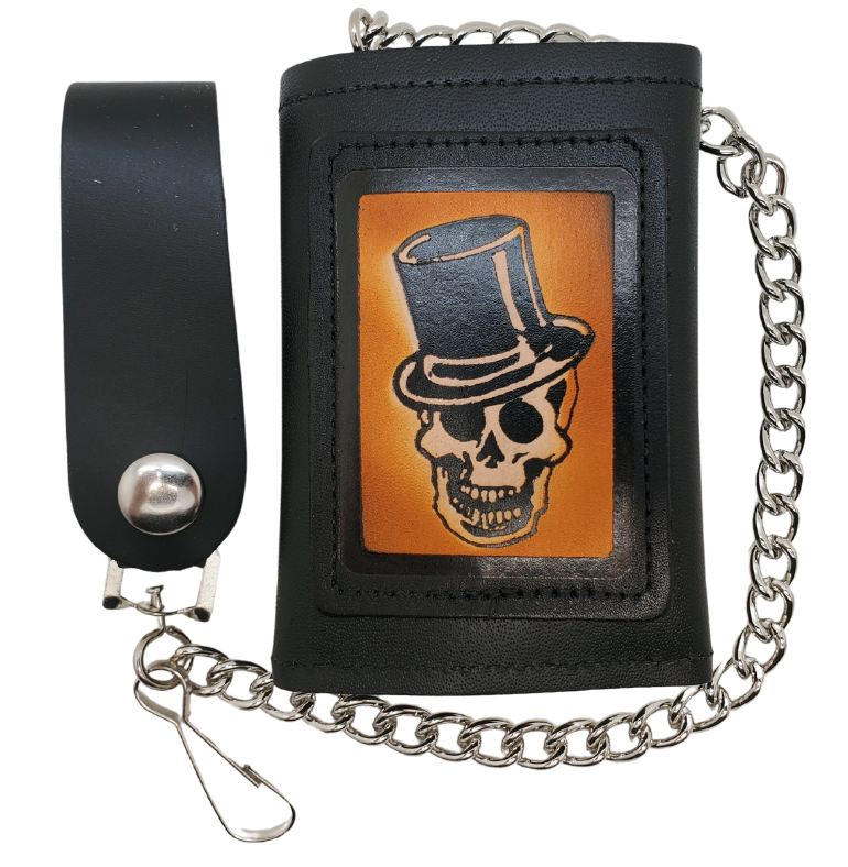 Skull Top Hat all leather Tri-fold Chain Wallet. 1 Cash Slot for all your important stash, 3 card slots and 1 underneath the middle slot. It's USA made and Buckle and Hide approved. Approx. 3"x 4" folded. 2 snap closure. Complete with an 12" chrome plated chain including leather belt loop. Available in our Smyrna, TN shop a short drive from downtown Nashville. Like most wallets over stuffing will limit the time of use. Colors may vary from picture.