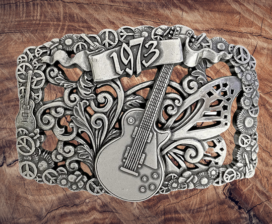 We named this after The 1973 concert featuring The Grateful Dead, Allman Brothers, &amp; The Band: and a HUGE crowd. The buckle has A Filigreed Butterfly, Peace signs, Les Paul guitar, Scroll and Flower designs in Antique Nickel color that looks great on plain 1 1/2" Black or Brown belt. A easy to wear oval shape that&