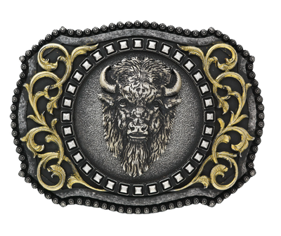 The Buffalo, a beloved Western symbol, now has a stylish and approachable accessory to complete your look. This rectangular belt buckle features a Brass-colored western scroll design with a Tantanka head in the center, surrounded by rounded bead edges. Measuring 3" tall by 4" wide, it's perfectly sized to fit belts up to 1 1/2" wide. You can find it at our retail shop in Smyrna, TN, located just outside of Nashville, or online. 