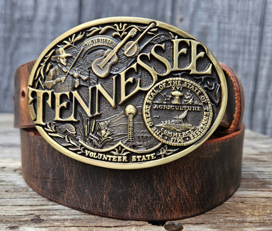 This Tennessee Belt with Montana Silversmith Buckle makes a great Combo. Features a 1 1/2" strap. Choose color: Distressed Brown or Black. The edges are beveled and finished. Available lengths from 34" to 44". The buckle is an Antiqued brass colored Tennessee State Buckle snapped in place. Belt is handmade in our shop in Smyrna, TN, just outside of Nashville