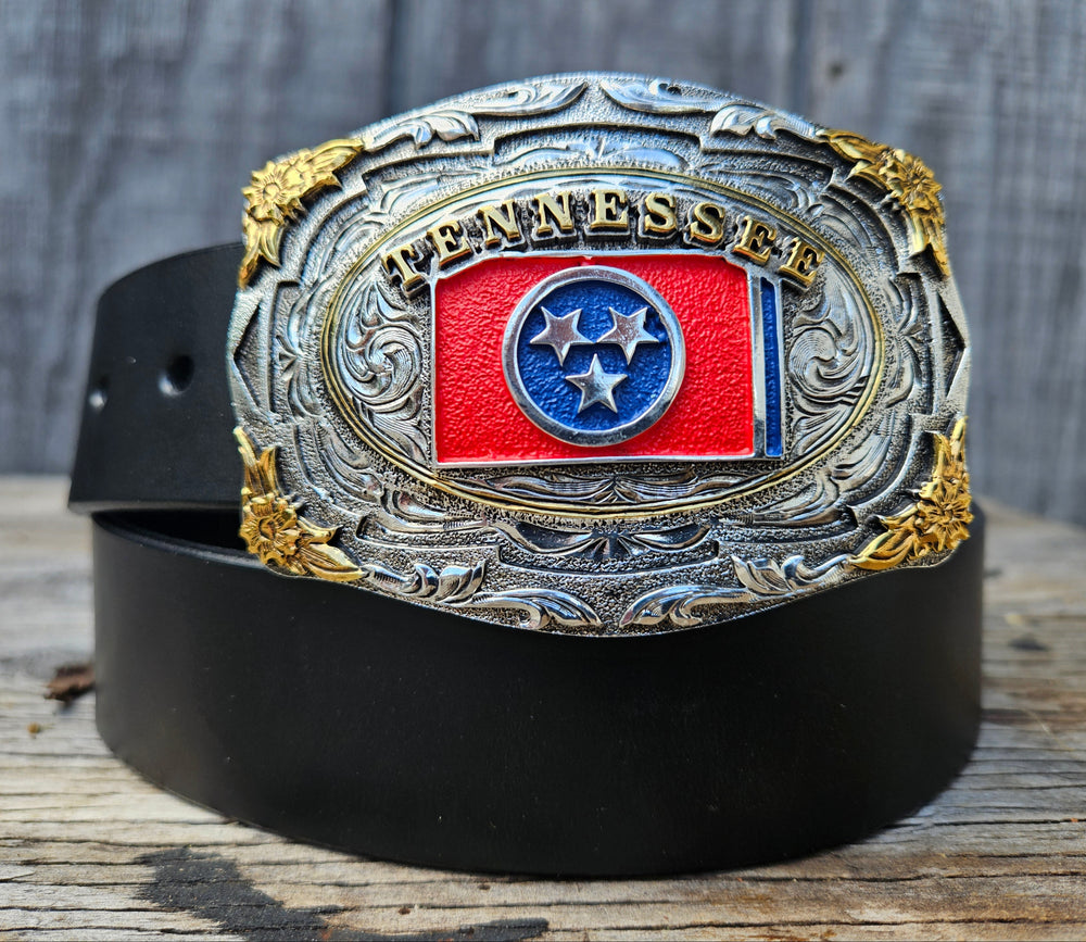 This Tennessee State Flag Belt with Buckle Combo features a 1 1/2" strap. Choose color: Distressed Brown or Black. The edges are beveled and finished. Available lengths from 34" to 44". The buckle is an Antiqued brass colored Tennessee State Buckle snapped in place. Belt is handmade in our shop in Smyrna, TN, just outside of Nashville.
