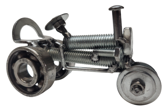 The perfect addition to your Man Cave! This metal art piece is a unique gift for any Tractor enthusiast. Featuring nuts, bolts, springs, and bearing wheels, even a spark plug. It even stands on it's own. Need more details? Take a look at the picture for dimensions. You can find it at our store in Smyrna, conveniently located just outside Nashville, TN.

Size is Approx. 5" long x 3" tall x 2" wide
Imported