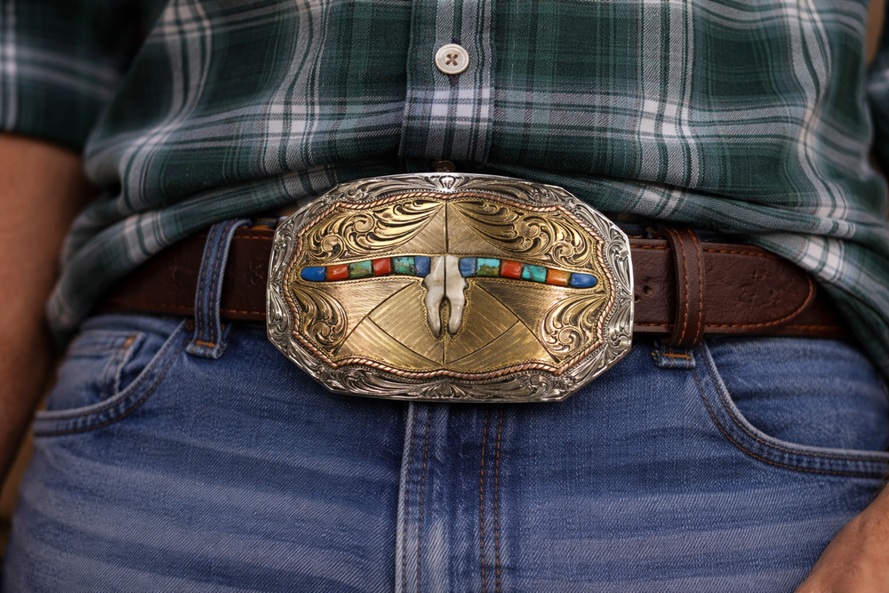 The Tumbleweed Belt Buckle has the ever classic Longhorn design accented with a multi colored stones. A Classic Western belt buckle at it's best! Made from German Silver and engraved and layered metals in a tri-color Western design. Available in our Smyrna, TN shop, a short distance from Nashville.

Dimensions: Width 4”, Height 2.7”
Standard 1.5” Swivel