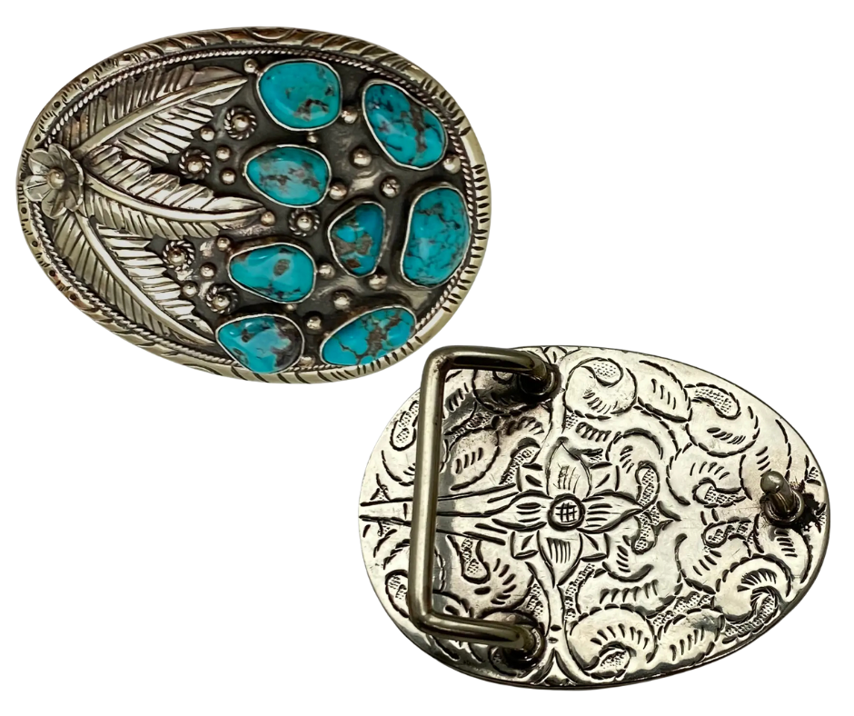 The Navajo influenced Turquoise Sky belt buckle&nbsp; It is crafted from white metal with turquoise and flowers on it and no 2 are alike because of the unique stones in each buckle. The measurement is approx. 3"x 4" and will fit up to 1 1 /2" belts. Ride on to our Smyrna, TN shop and check'em out!

Handcrafted in Nepal.
Floral design back