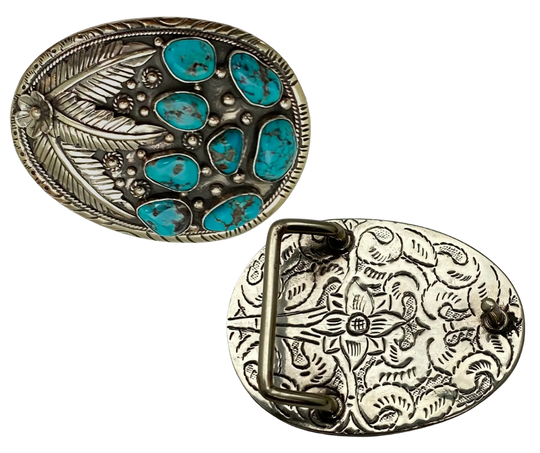 The Navajo influenced Turquoise Sky belt buckle&nbsp; It is crafted from white metal with turquoise and flowers on it and no 2 are alike because of the unique stones in each buckle. The measurement is approx. 3"x 4" and will fit up to 1 1 /2" belts. Ride on to our Smyrna, TN shop and check'em out!

Handcrafted in Nepal.
Floral design back