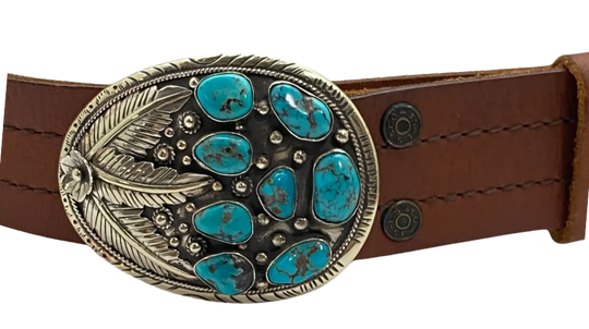 The Navajo influenced Turquoise Sky belt buckle&nbsp; It is crafted from white metal with turquoise and flowers on it and no 2 are alike because of the unique stones in each buckle. The measurement is approx. 3"x 4" and will fit up to 1 1 /2" belts. Ride on to our Smyrna, TN shop and check'em out!

Handcrafted in Nepal.
Floral design back