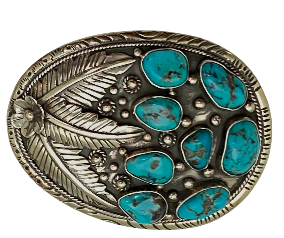 The Navajo influenced Turquoise Sky belt buckle&nbsp; It is crafted from white metal with turquoise and flowers on it and no 2 are alike because of the unique stones in each buckle. The measurement is approx. 3"x 4" and will fit up to 1 1 /2" belts. Ride on to our Smyrna, TN shop and check'em out!

Handcrafted in Nepal.
Floral design back