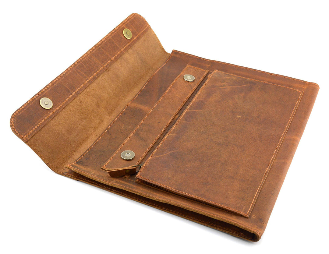 The Analyst is a tablet or thin laptop sleeve handmade from full-grain leather. A practical gift idea for yourself, family, or friends. Offered in a 13" or a 15". Side gussets extend approximately 3/4 inches on each side for both the main pocket and the accessory pocket. Distressed brown leather with antique brass magnet closures and zipper. Part of our Home Office items now at our Smyrna, TN shop.
