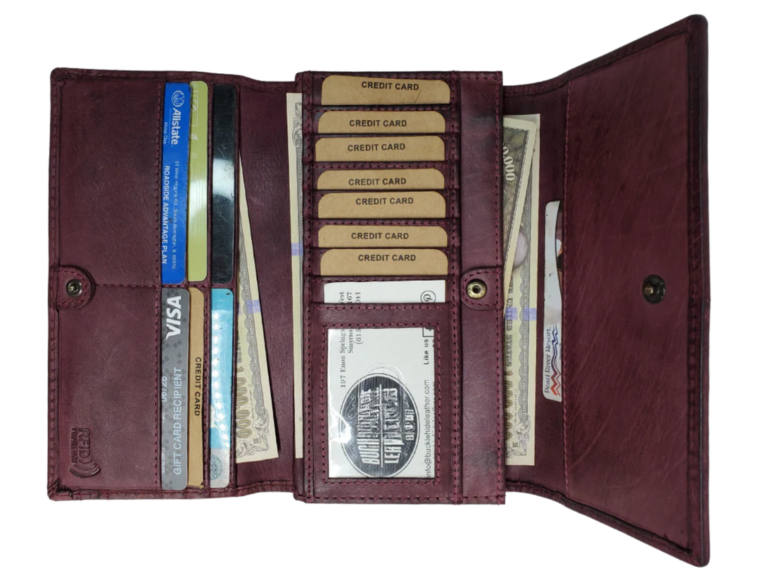 Open brown leather wallet with credit cards and money on a white background