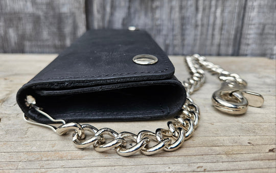 The Cruiser" 13 Pocket Chain Wallet has cards for almost everything. It has 3 folding sections to hold cards, money, receipts, and more!

Simple Black Tri-Fold Biker Wallet
13 Card Slots
1 Clear ID slot
Inside pocket with zipper
Secure Snap Closure
7.00” x 3.75"