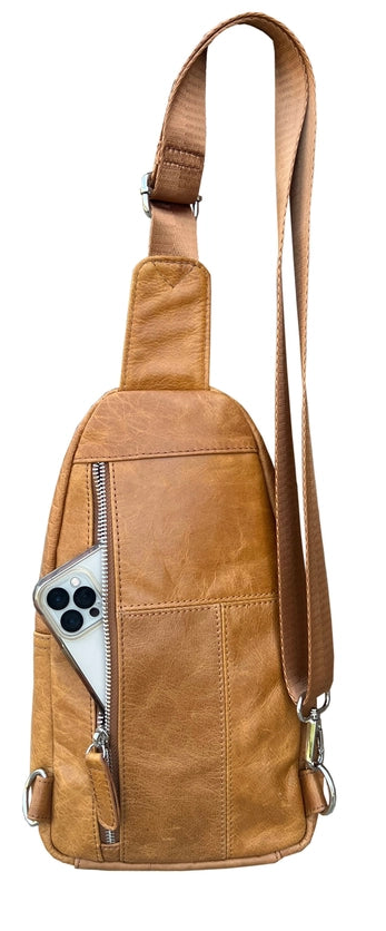 The Daily Carry Sling bag has two spacious main compartments. One main compartment has Interior throw pocket and 1 zipper pocket 1 exterior vertical zipper pocket on front side for your accessories. Backside has 1 vertical zipper pocket Metal loops are to adjust which side the strap attaches Adjustable shoulder strap, Leather pulls

Material: Cowhide leather Colors: black, cream, light brown
Size: 11 ¼”x 6½”x 3”