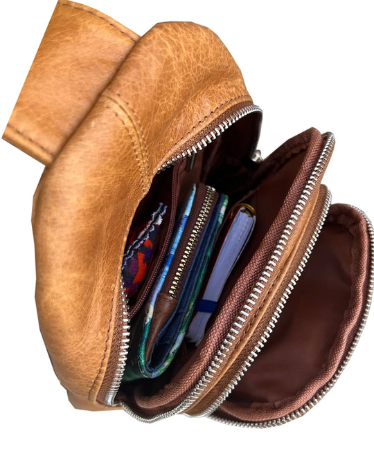 The Daily Carry Sling bag has two spacious main compartments. One main compartment has Interior throw pocket and 1 zipper pocket 1 exterior vertical zipper pocket on front side for your accessories. Backside has 1 vertical zipper pocket Metal loops are to adjust which side the strap attaches Adjustable shoulder strap, Leather pulls

Material: Cowhide leather Colors: black, cream, light brown
Size: 11 ¼”x 6½”x 3”