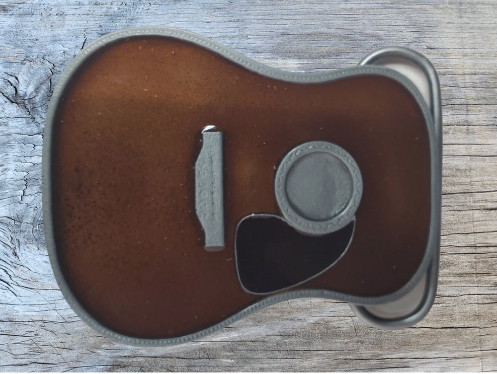 Strut your style with the iconic "Martin" Belt Buckle! This 2 1/2" tall by 3 1/2" wide buckle is fit for all music genres, from Rock to Bluegrass, Jazz to Folk. Let the world know your passion for playing guitar! Just outside of Nashville, home of the Acoustic Guitar, you can find the belt buckle in our Smyrna, TN shop online.