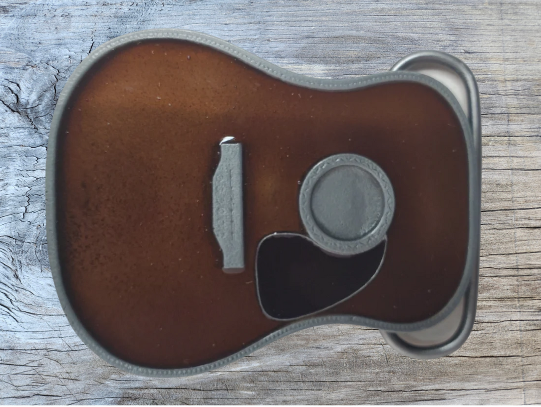 Strut your style with the iconic "Martin" Belt Buckle! This 2 1/2" tall by 3 1/2" wide buckle is fit for all music genres, from Rock to Bluegrass, Jazz to Folk. Let the world know your passion for playing guitar! Just outside of Nashville, home of the Acoustic Guitar, you can find the belt buckle in our Smyrna, TN shop online.