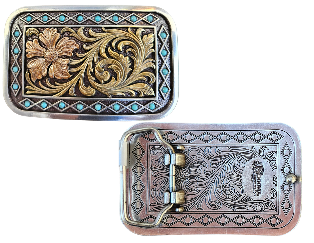 The Occidental is a rectangle buckle with a pearl copper flower and antique gold scrolling in the center. Diamond shaped filigree with turquoise stones around the smooth edge. Pearl Copper Flower, Turquoise Stones on Edge. 98% Zinc, 1% Stone, 1% Iron. Approximate Size 2 x 3-1/2. You can find it at our retail shop in Smyrna, TN, located just outside of Nashville, or online.

Measuring 2" tall by 3 1/2" wide
Fit&