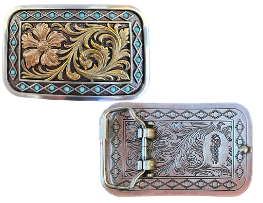 The Occidental is a rectangle buckle with a pearl copper flower and antique gold scrolling in the center. Diamond shaped filigree with turquoise stones around the smooth edge. Pearl Copper Flower, Turquoise Stones on Edge. 98% Zinc, 1% Stone, 1% Iron. Approximate Size 2 x 3-1/2. You can find it at our retail shop in Smyrna, TN, located just outside of Nashville, or online.

Measuring 2" tall by 3 1/2" wide
Fit&