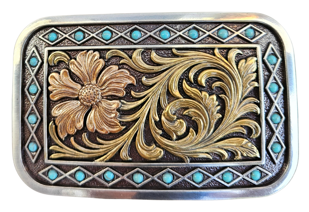The Occidental is a rectangle buckle with a pearl copper flower and antique gold scrolling in the center. Diamond shaped filigree with turquoise stones around the smooth edge. Pearl Copper Flower, Turquoise Stones on Edge. 98% Zinc, 1% Stone, 1% Iron. Approximate Size 2 x 3-1/2. You can find it at our retail shop in Smyrna, TN, located just outside of Nashville, or online.

Measuring 2" tall by 3 1/2" wide
Fit&