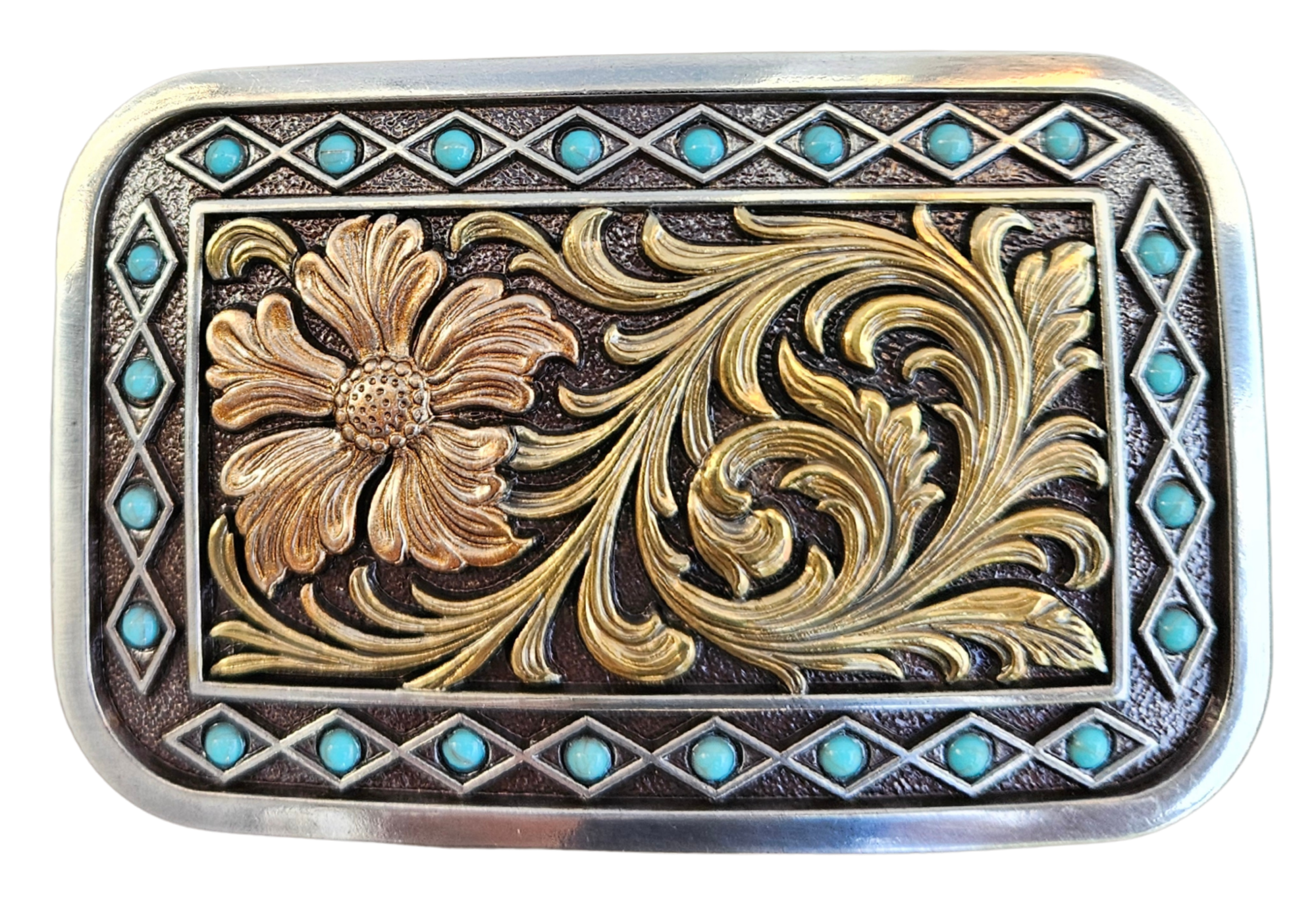 The Occidental is a rectangle buckle with a pearl copper flower and antique gold scrolling in the center. Diamond shaped filigree with turquoise stones around the smooth edge. Pearl Copper Flower, Turquoise Stones on Edge. 98% Zinc, 1% Stone, 1% Iron. Approximate Size 2 x 3-1/2. You can find it at our retail shop in Smyrna, TN, located just outside of Nashville, or online.

Measuring 2" tall by 3 1/2" wide
Fit's belts up to 1 1/2" wide.
Imported