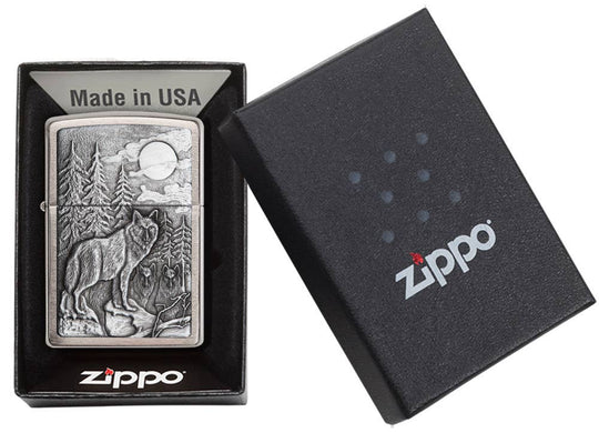 This Brushed Chrome windproof lighter has an emblem attached displaying a timber wolves in the wilderness. All metal construction; windproof design works virtually anywhere. Refillable for a lifetime of use. Comes packaged in a gift box. Available in our Smyrna, TN shop.

Made in USA
Fuel: Zippo lighter fuel (sold separately)
Lighter Specs: Height: 2.25" Width: 0.5" Depth: 1.5" Weight: 2.0 oz
Lifetime guarantee that "it works or we fix it free™" Zippo contact info on gift box.