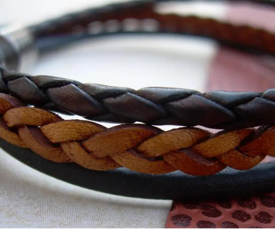 This 3 color braided leather bracelet features Three Strands of Fine Imported Quality Leather Cord. This unique cord is made by braiding 8 individual strands of leather. A secure stainless steel magnetic closure clasp serves as a magnificent visual center piece. Available at Buckle and Hide leather in Smyrna, TN.