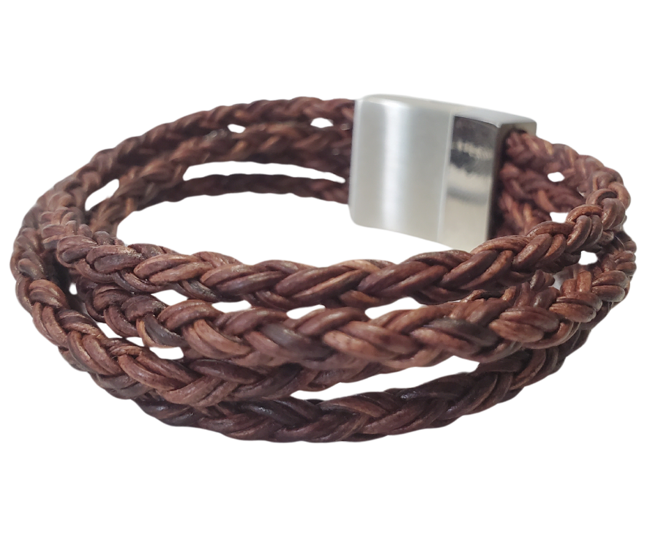 This  leather bracelet style features Four strands of braided 5mm High Quality Leather Cord. This unique cord is made by braiding 8 individual strands of leather. A secure slide magnetic clasp serves as a magnificent visual center piece. Available at Buckle and Hide leather in Smyrna, TN.