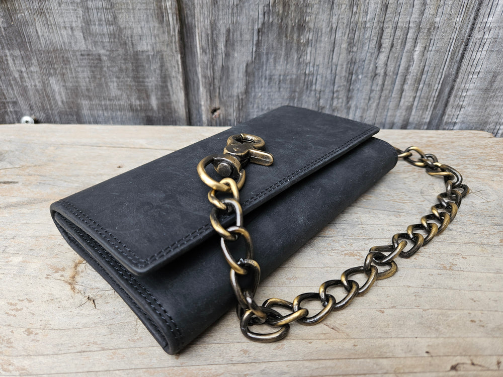 Popular Long Style RFID Secure Tri-fold Chain Wallet. 3 underneath cash slots, 15 card slots, I.D. slot, zippered pocket for all your important stash. Will darken with a nice patina with use. It's imported but it's Buckle and Hide approved. Standard long tri-fold size. Size is 7" x 3 3/4" when snapped closed. Fully open is 10 1/2" x 6 3/4". Antique Brass colored chain and snaps. Chain length is 12"-15". Imported