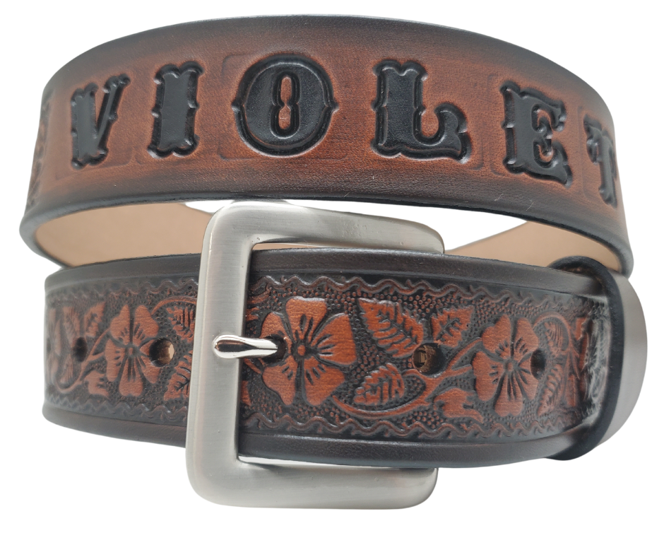 "The Wallflower" is a handmade real leather belt made from a single strip of cowhide shoulder leather that is 8-10 oz. or approx. 1/8" thick. It has hand burnished (smoothed) edges and summer flowers embossed in 3 color options. The antique nickel plated solid brass buckle is snapped in place with heavy snaps. This belt is made just outside Nashville in Smyrna, TN.