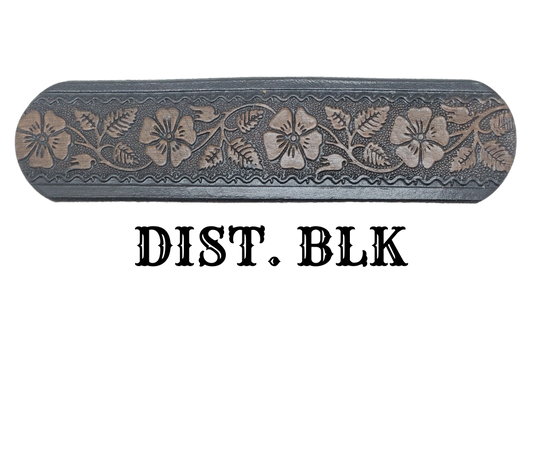 "The Wallflower" is a handmade real leather belt made from a single strip of cowhide shoulder leather that is 8-10 oz. or approx. 1/8" thick. It has hand burnished (smoothed) edges and summer flowers embossed in 3 color options. The antique nickel plated solid brass buckle is snapped in place with heavy snaps. This belt is made just outside Nashville in Smyrna, TN.