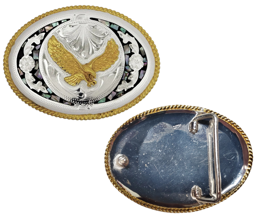 The "Isaiah's Eagle" belt buckle is a stylish showstopper. Crafted from German Silver with a brass overlay and shimmering abalone inlay, it showcases a soaring eagle framed by a rope-edged oval. Designed to fit belts up to 1 3/4" wide, this 4" x 3" buckle adds a bold touch to any outfit. Made in China and available at our Smyrna, TN shop near Nashville, it’s the perfect blend of flair and craftsmanship.