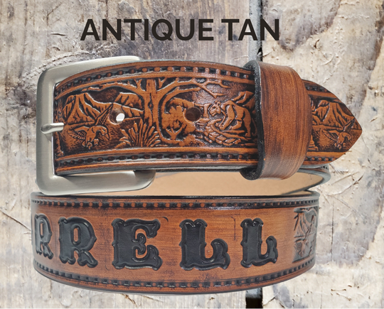 Wilderness leather belt in antique brown, coiled on a rustic wood background. 