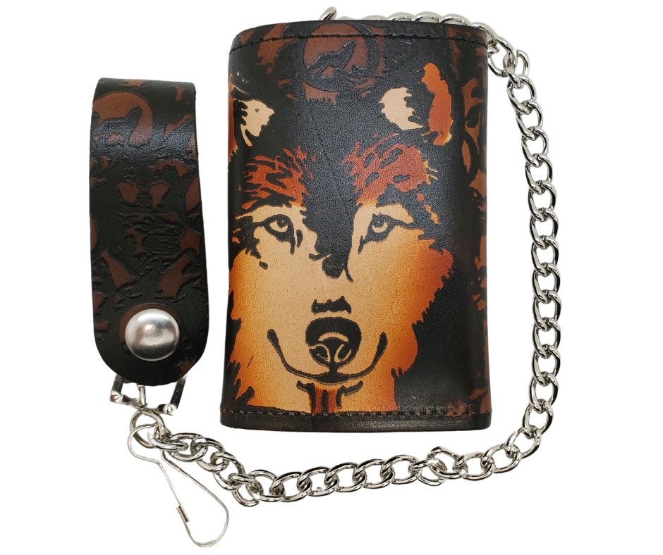 Wolf "all over" pattern Leather Patch all leather Tri-fold Chain Wallet. 1 Cash Slot for all your important stash, 3 card slots and 1 underneath the middle slot. It's<em data-mce-fragment="1"><strong data-mce-fragment="1">&nbsp;USA made&nbsp;</strong></em><span>and Buckle and Hide approved. Approx. 3"x 4" folded. 2 snap closure. Complete with an 12" chrome plated chain including leather belt loop. Available in our Smyrna, TN shop a short drive from downtown Nashville. </span>